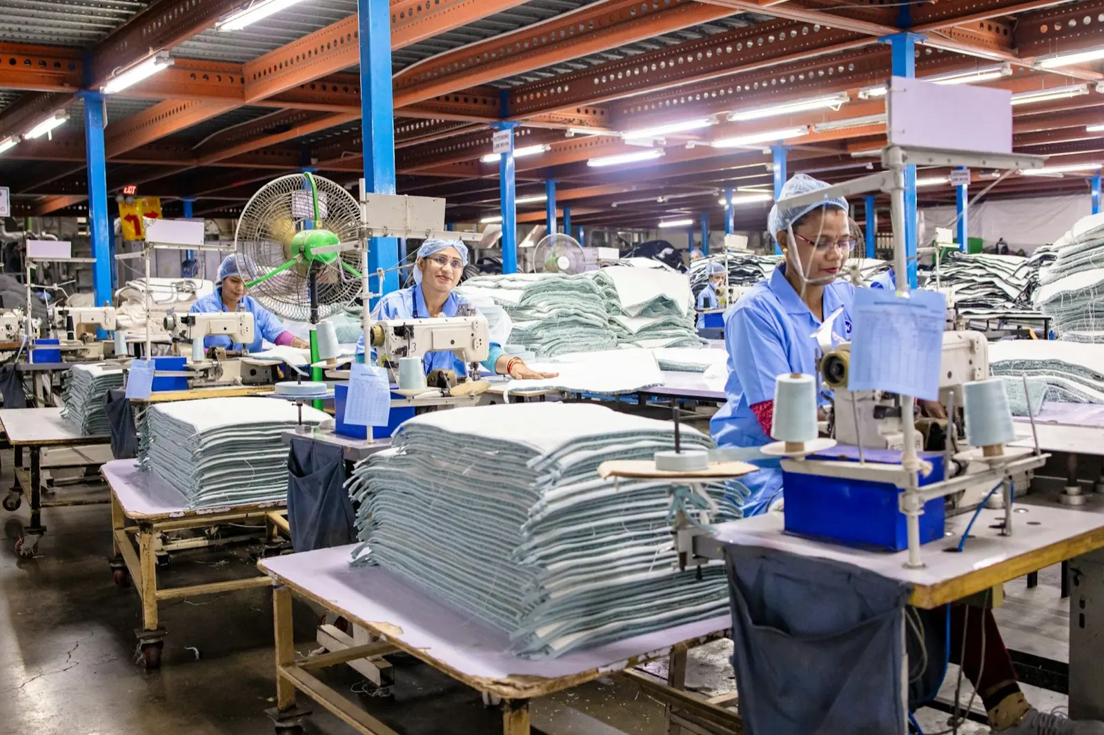 Garment workers sewing textiles in a modern production floor